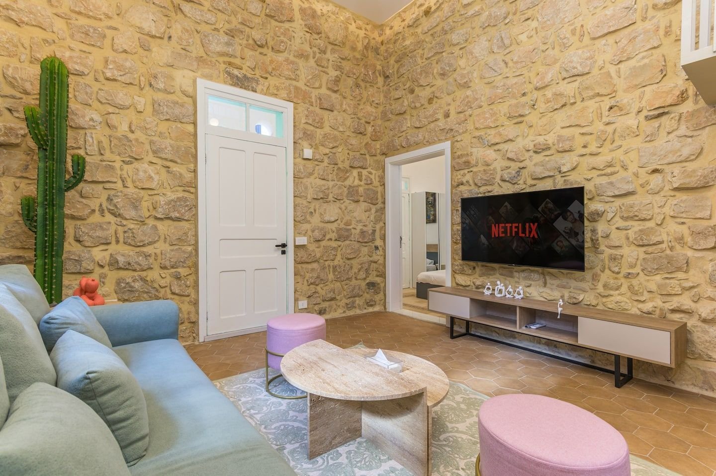 Lounge with stone wall and smart TV, Heritage Loft 2-Bedroom in Achrafieh