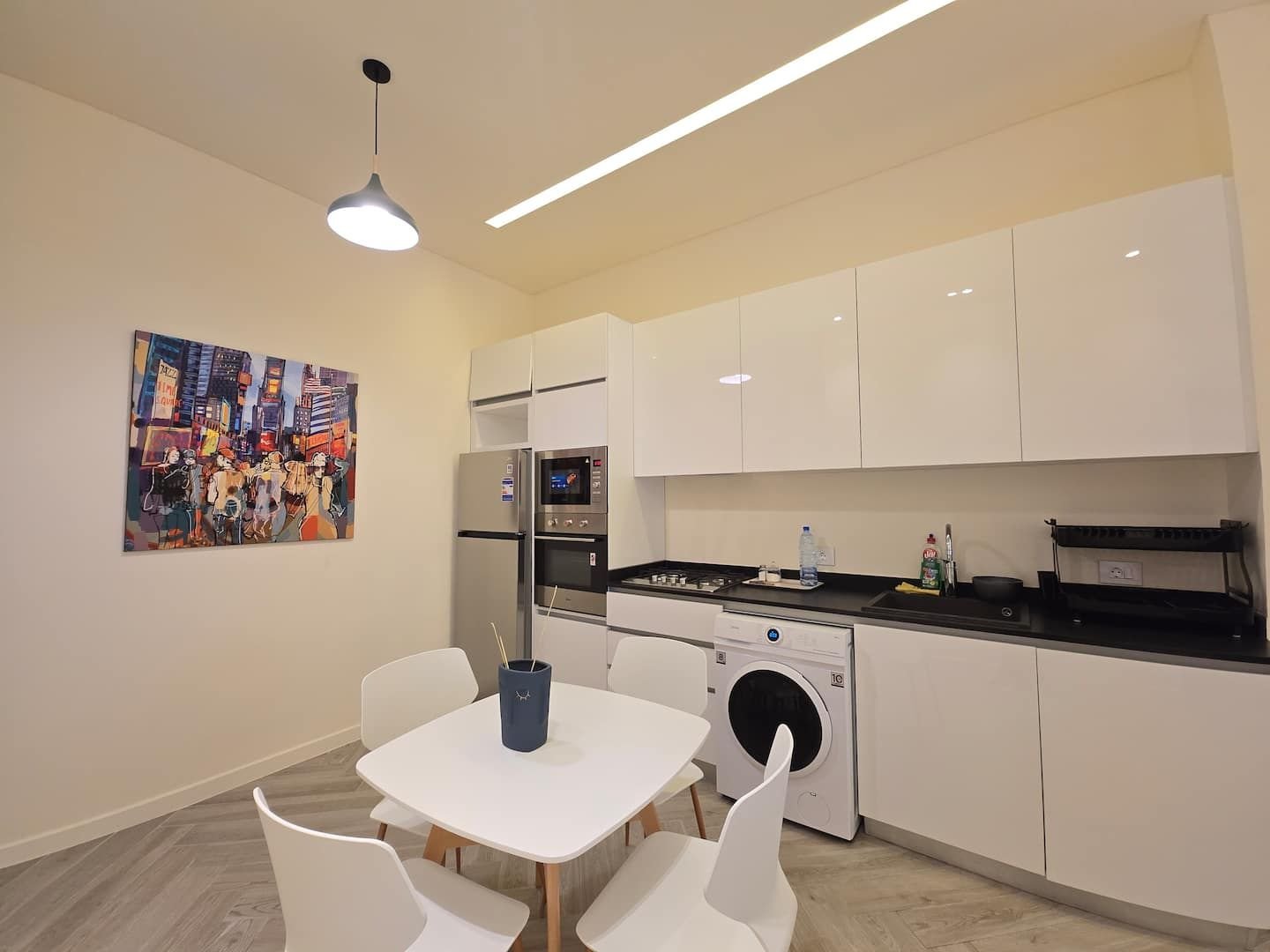 Kitchen with washing machine and dining table, Modern Achrafieh 1-Bedroom with 24/7 Power