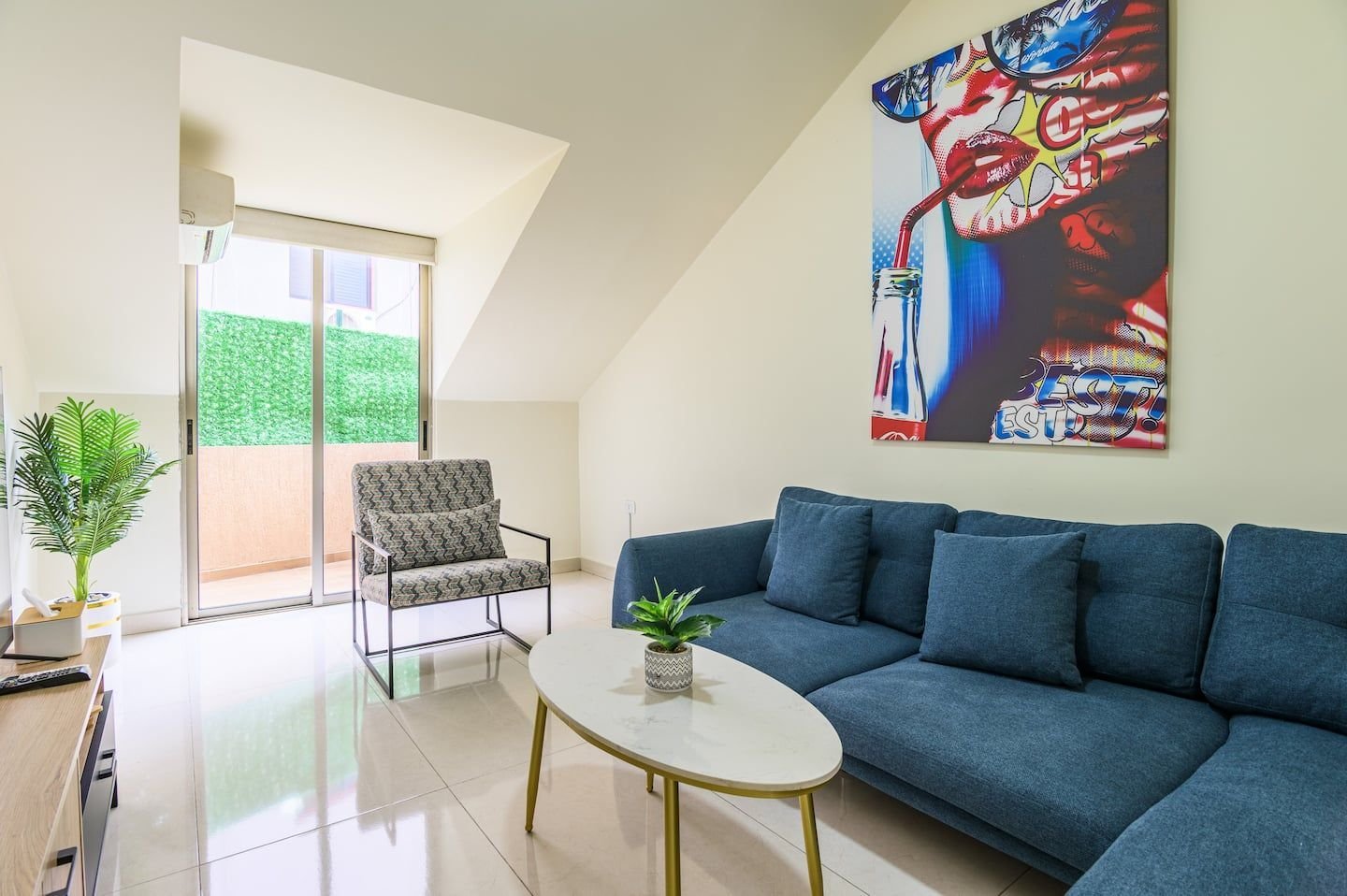 Living room with blue sofa, Modern Rooftop 1-Bedroom in Bauchrieh