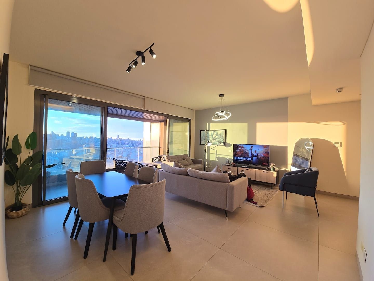 Dining table by the windows, City Skyline 3-Bedroom with Pool, Gym & Playground