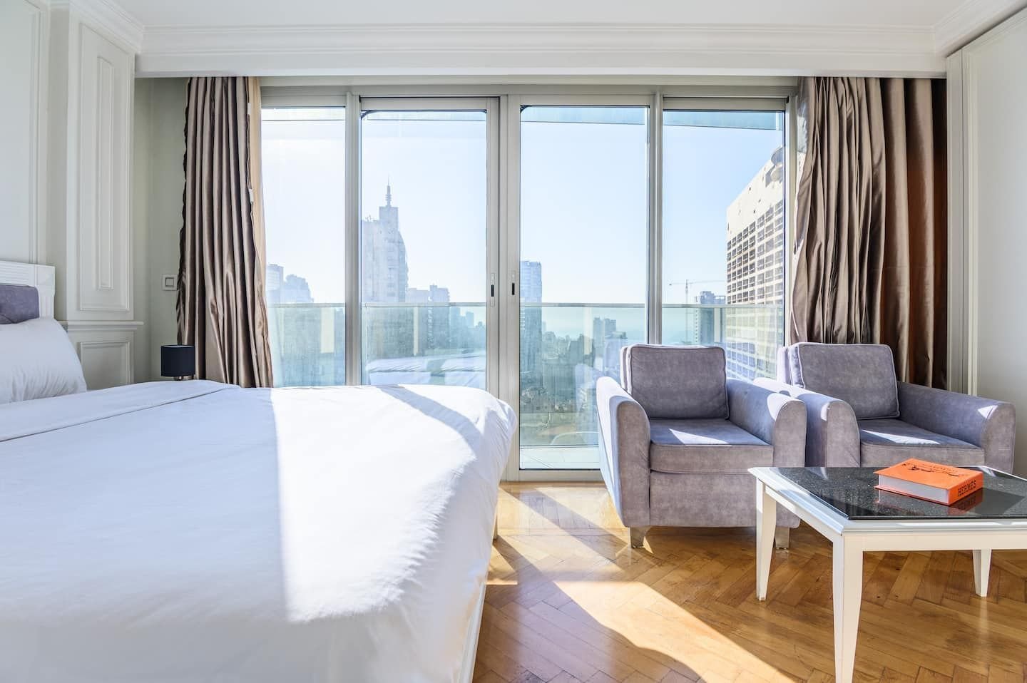 King bed and armchairs by the window, Panoramic Sea-View Studio in the Versace Tower