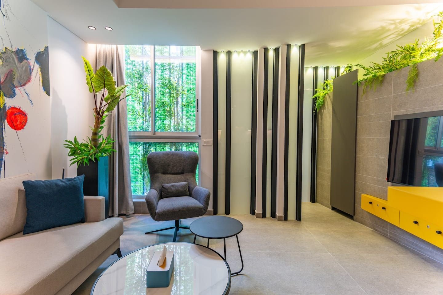 Living room with green plant wall, The Atelier at Retro 67