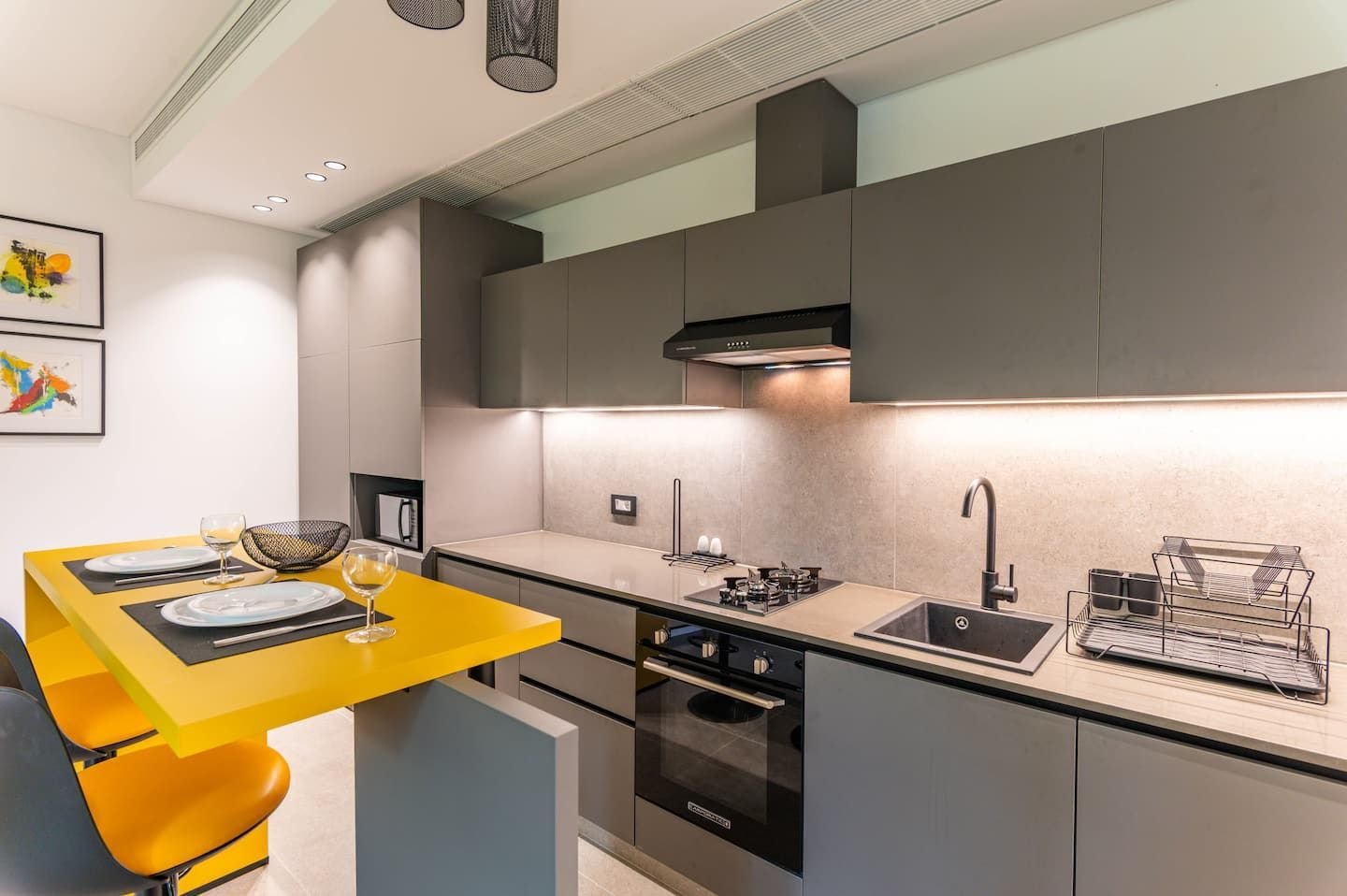 Kitchen with yellow breakfast bar, The Atelier at Retro 67