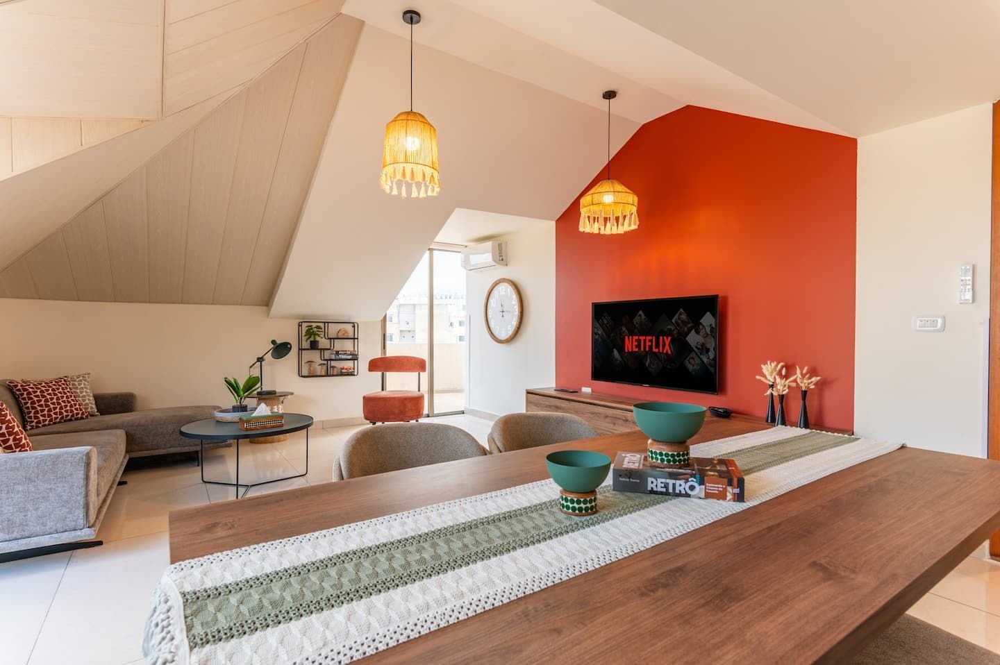 Boho living room with orange feature wall, Chic Boho 2-Bedroom with Private Terrace
