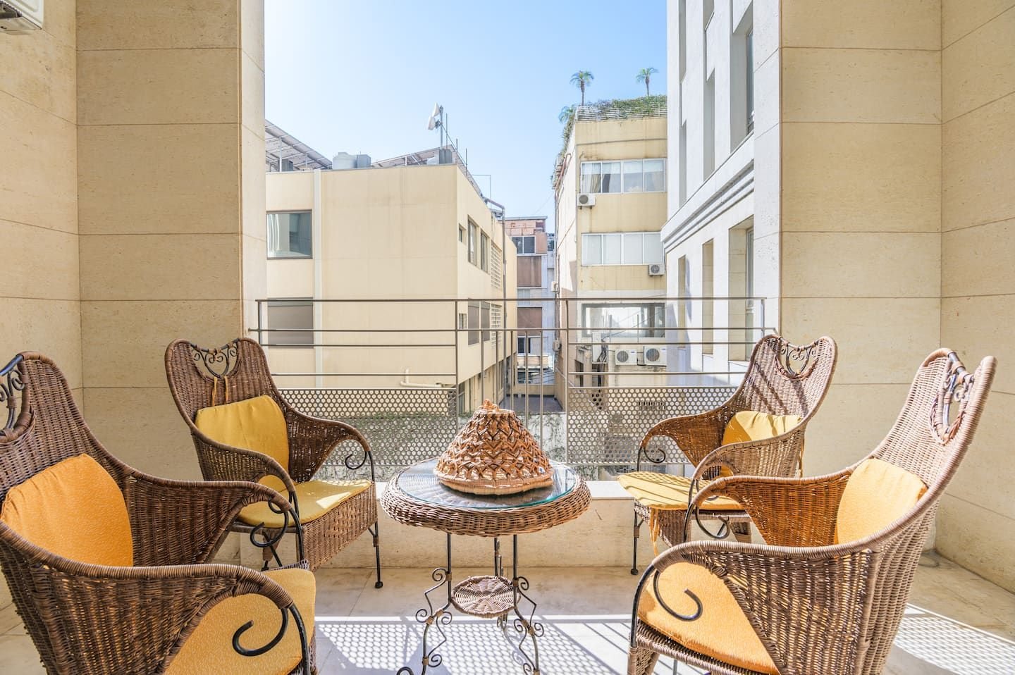 Balcony with rattan lounge chairs, Saifi 1-Bedroom with King Bed, Pool & Gym