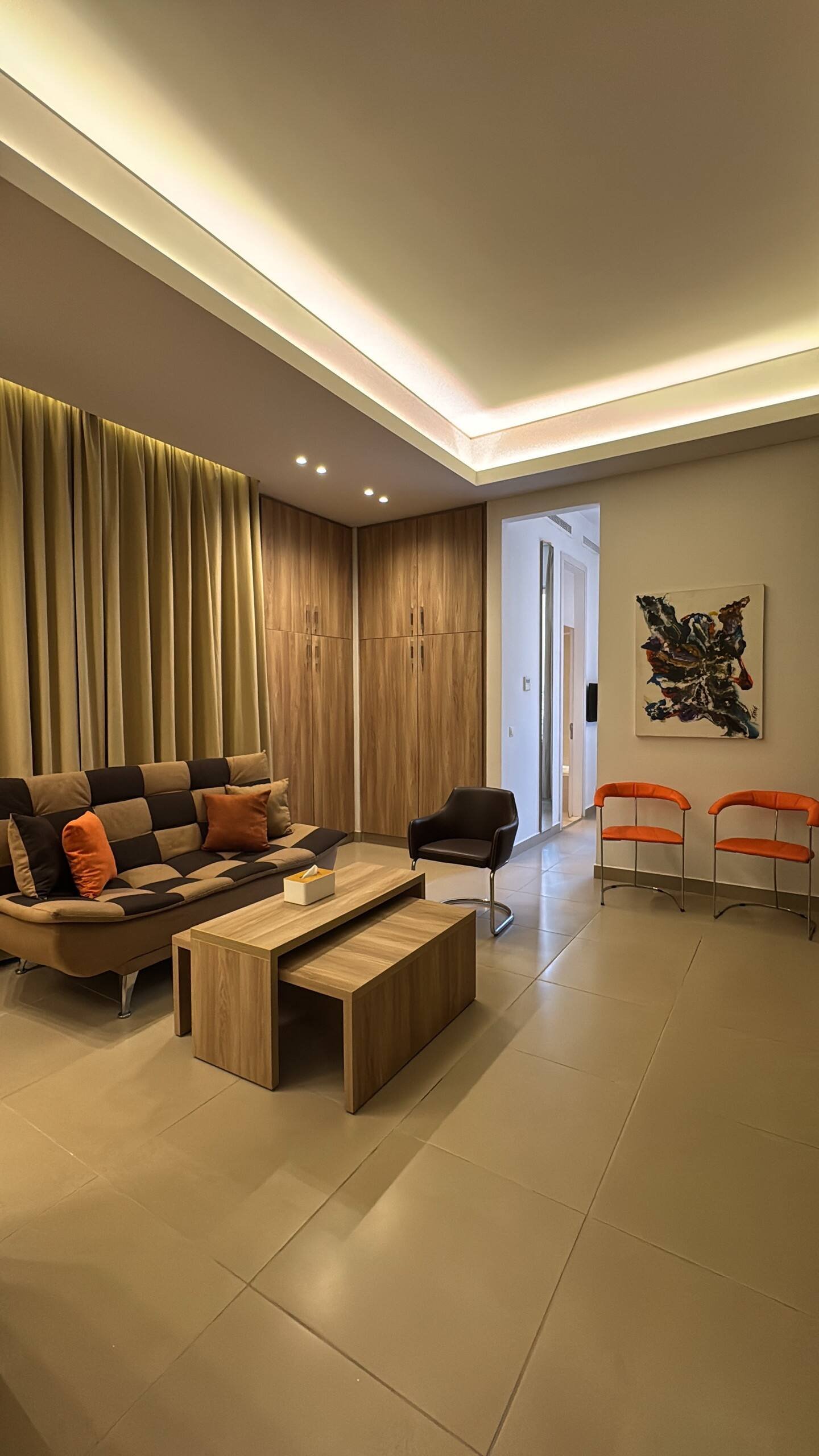 Living room with sofa and orange chairs, Saifi 1-Bedroom with Heated Pool, Gym & Parking