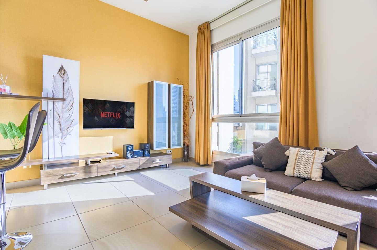 Living room with sofa and smart TV, Modern Saifi 1-Bedroom with Heated Pool