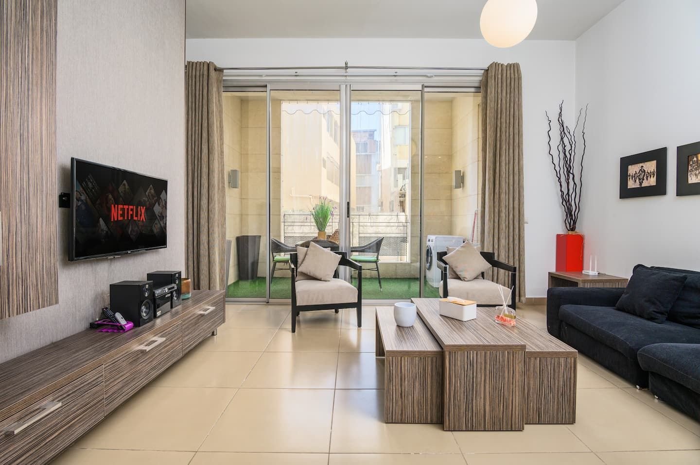Living room opening onto the balcony, Central 1-Bedroom with Pool & Gym